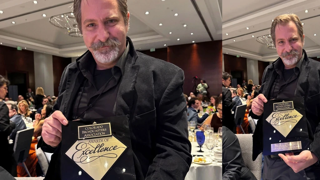 Home Andre Bruni holding his 2024 Colorado Broadcasters Association Award of Excellence for Best Commercial